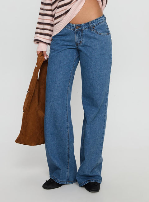 side view of model wearing Princess Polly Highlands Low Rise Wide Leg Jeans Mid Blue Wash Low Rise Jeans 