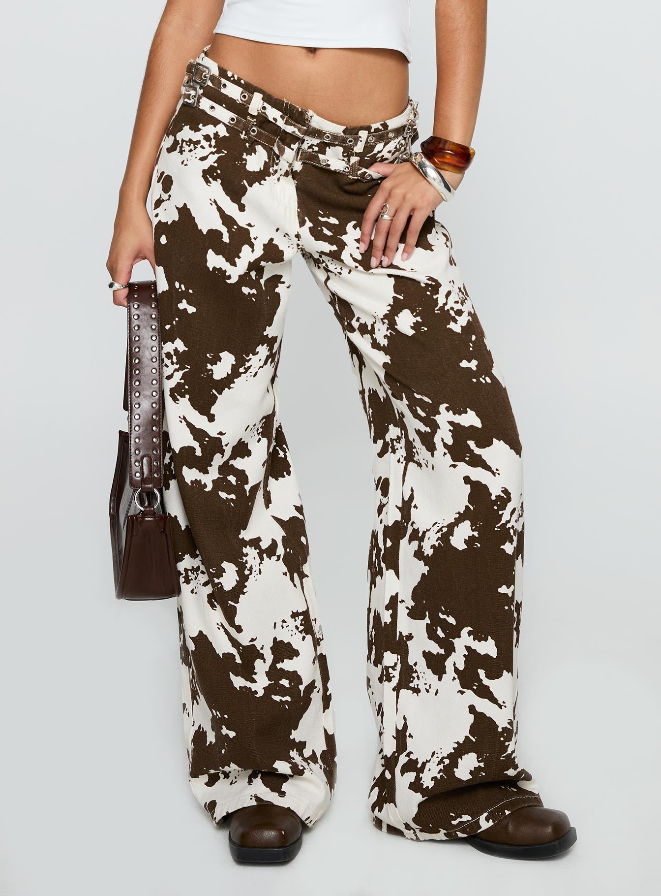 back view of model wearing Princess Polly Baccarat Belted Pant Cow Print Low Rise Jeans 