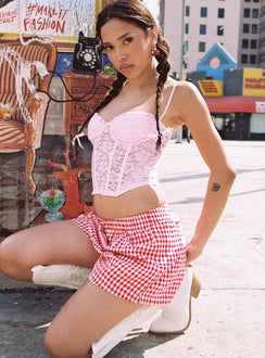 side view of model wearing Princess Polly Beach House Shorts Red / White Gingham 