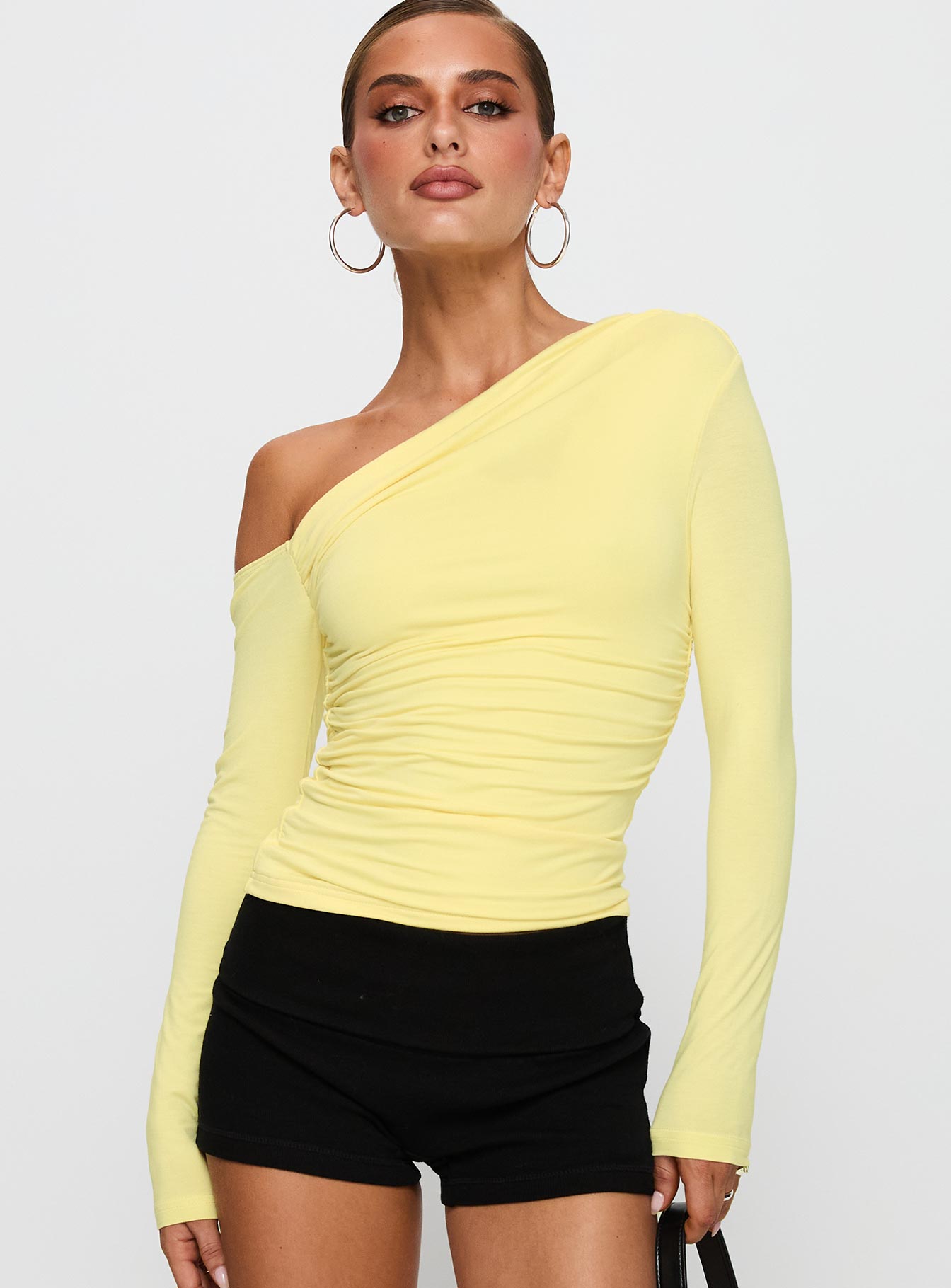 front view of model wearing Princess Polly Beller Long Sleeve Top Lemon Full Sleeves Asymmetric Neckline 