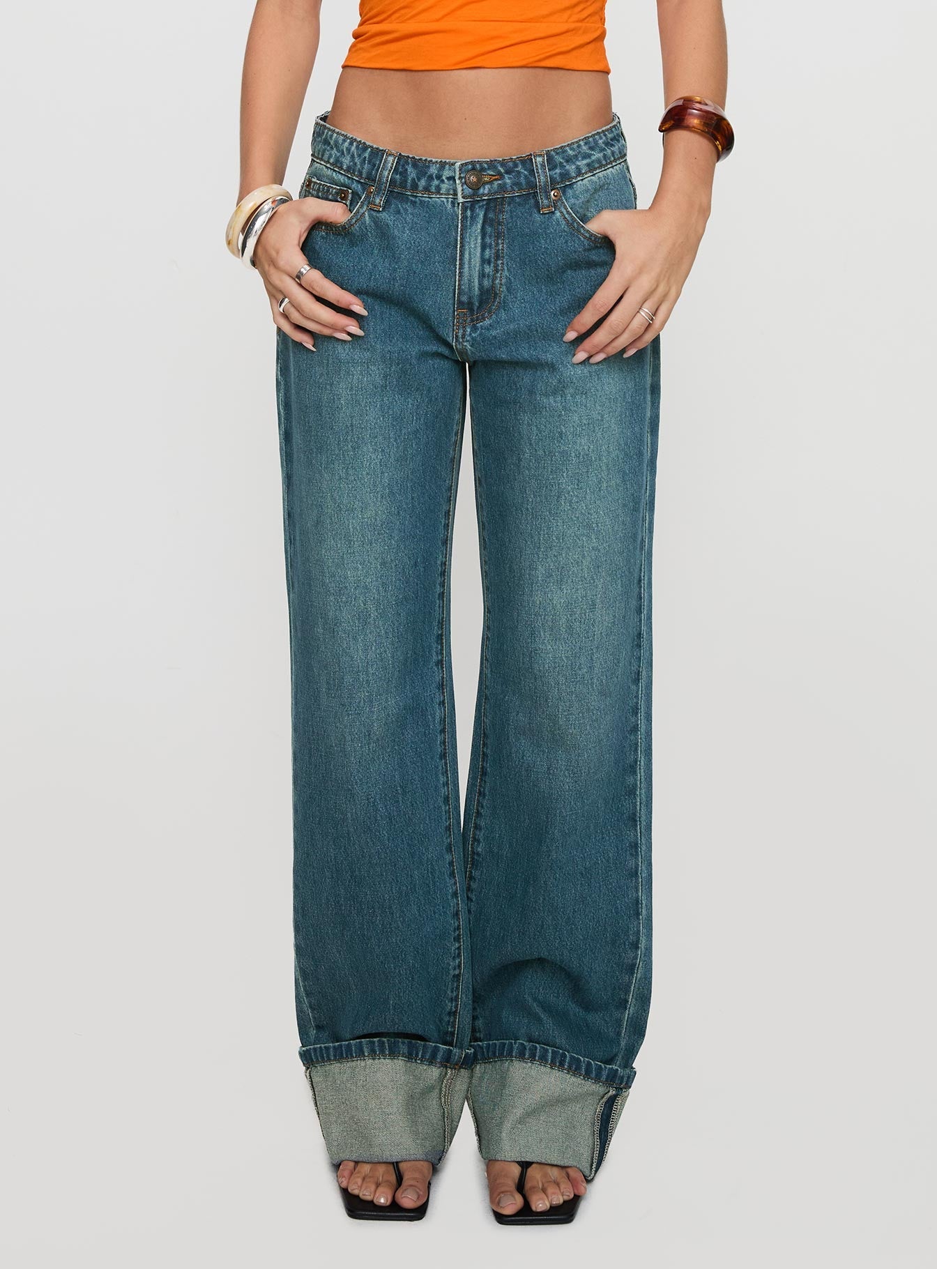 front view of model wearing Princess Polly Toros Mid Rise Wide Leg Foldover Denim Jeans Mid Blue Low Rise Jeans 