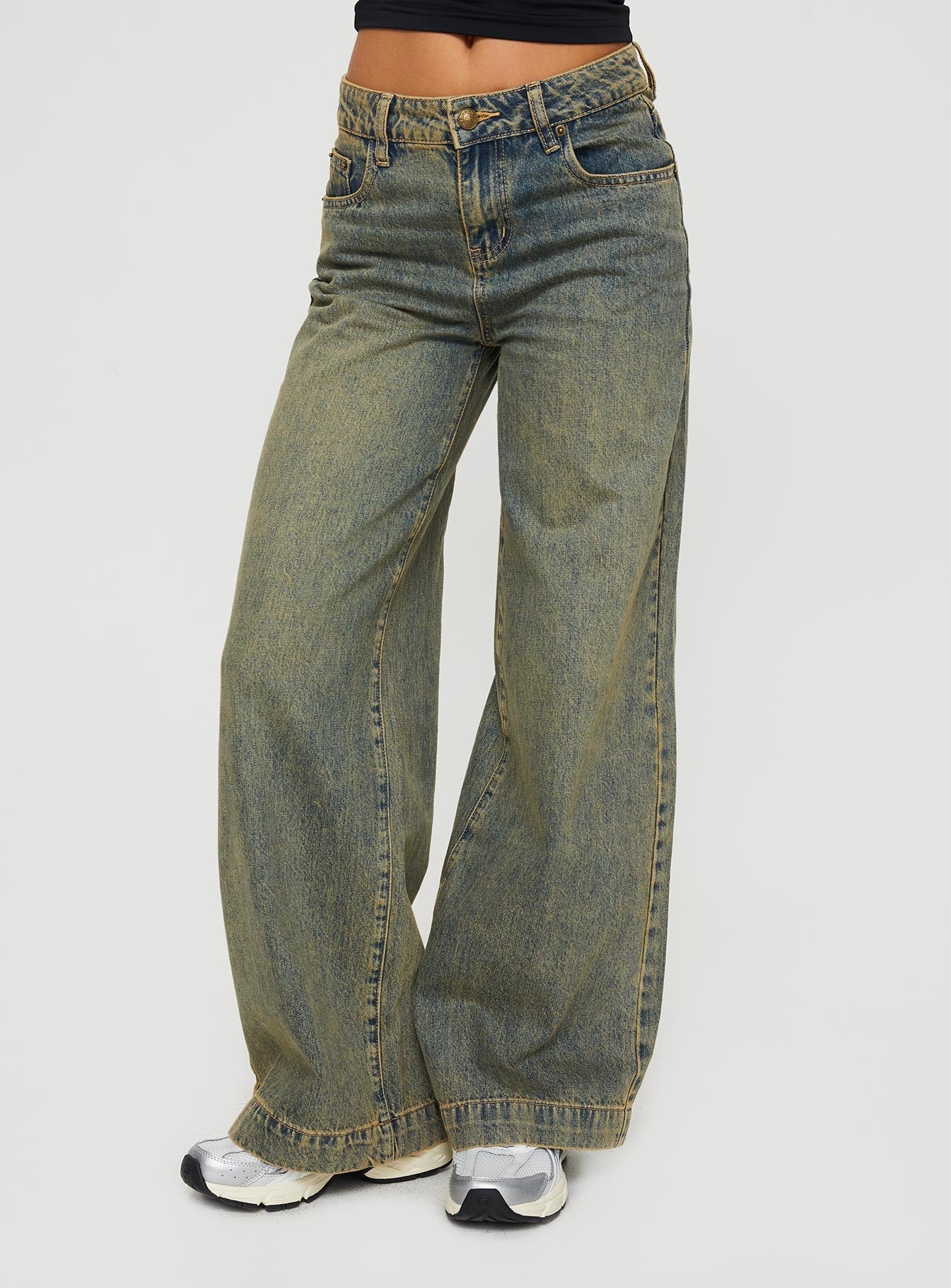 side view of model wearing Princess Polly Tap In Mid Rise Jeans Tea Wash Mid Rise 