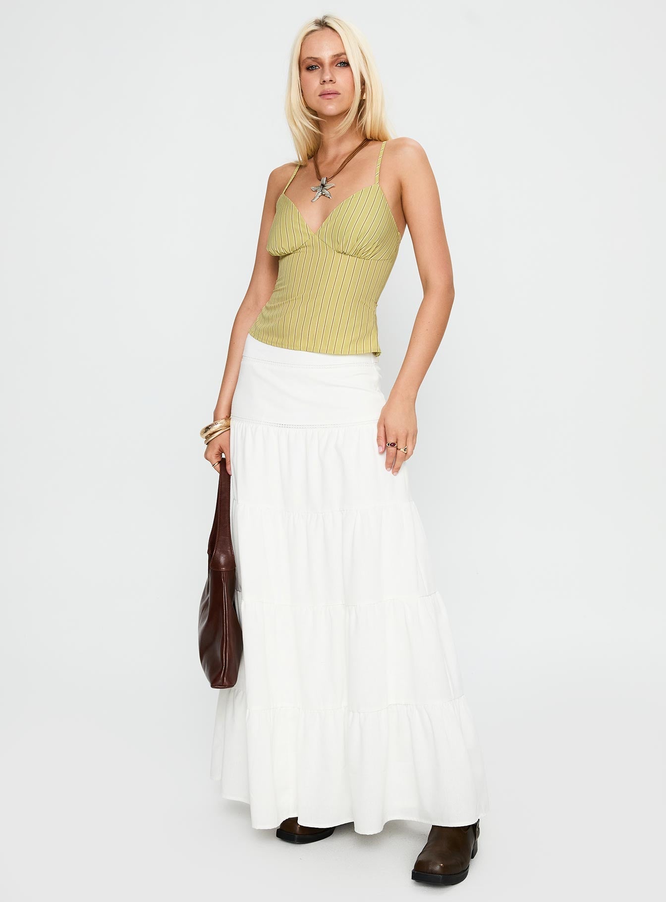   side view of model wearing Princess Polly Snowy River Tiered Maxi Skirt White Maxi 