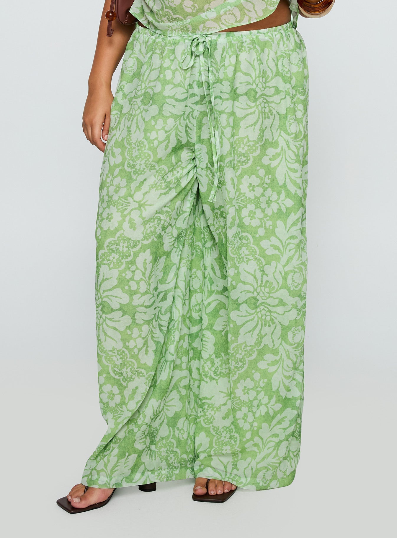 back view of model wearing Princess Polly Finesse Pants Green Floral Curve High Waisted Pants 