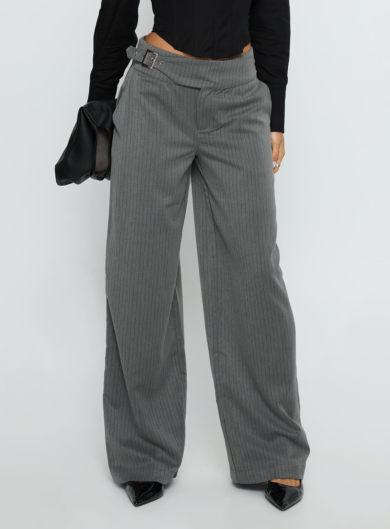 side view of model wearing Princess Polly Jinny Relaxed Buckle Tailored Pants Grey Pinstripe Low Rise Pants 