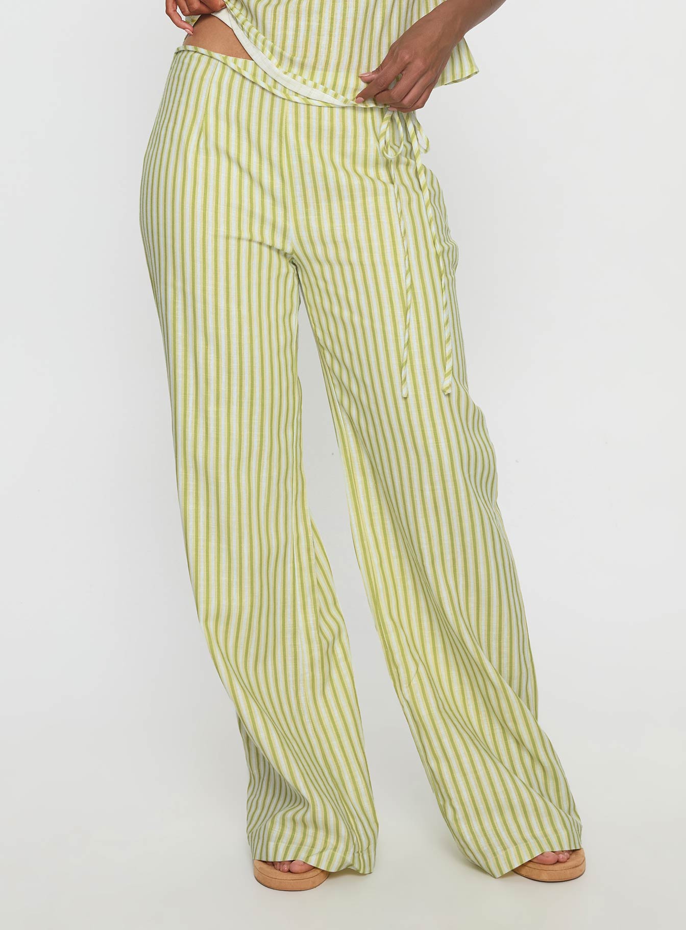 side view of model wearing Princess Polly With Pleasure Tie Side Pant Green / Blue Stripe Mid Rise Pants 