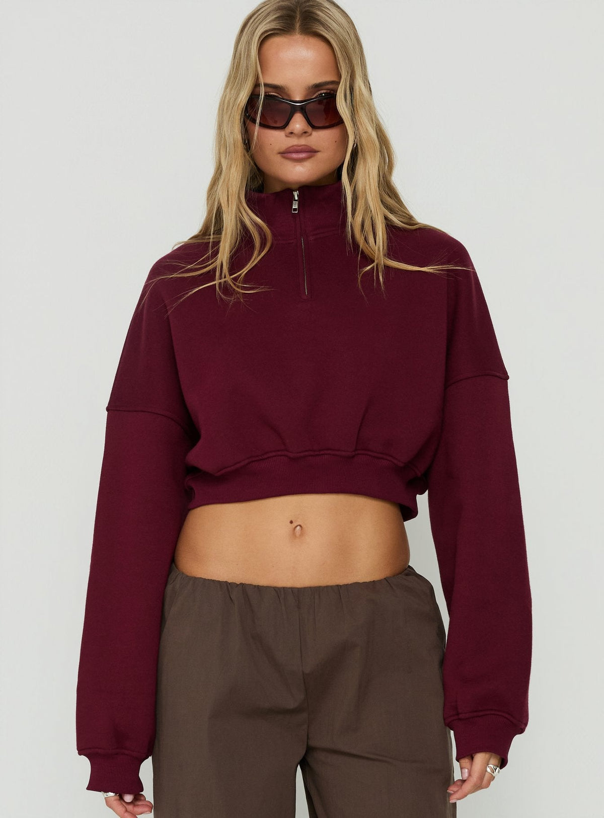 Showcasing the Astridd 3/4 Zip Cropped Jumper Cherry womens-jumpers with short length front view of model wearing Princess Polly