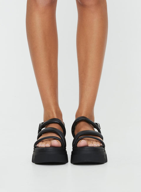 Faux leather sandals Rounded toe, chunky treaded sole, buckle fastening at ankle