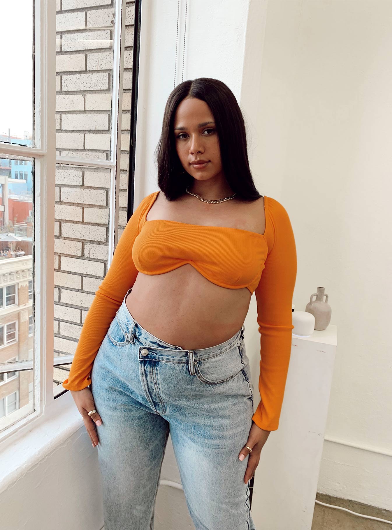 side view of model wearing Princess Polly Becca Long Sleeve Crop Top Orange Curve 