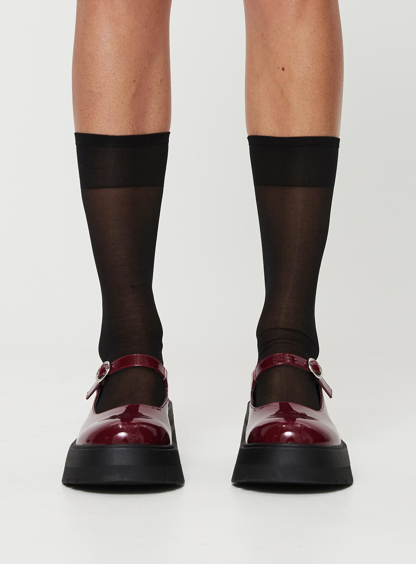 Faux patent leather loafer Platform base, treaded sole, single strap upper, silver-toned hardware, buckle fastening