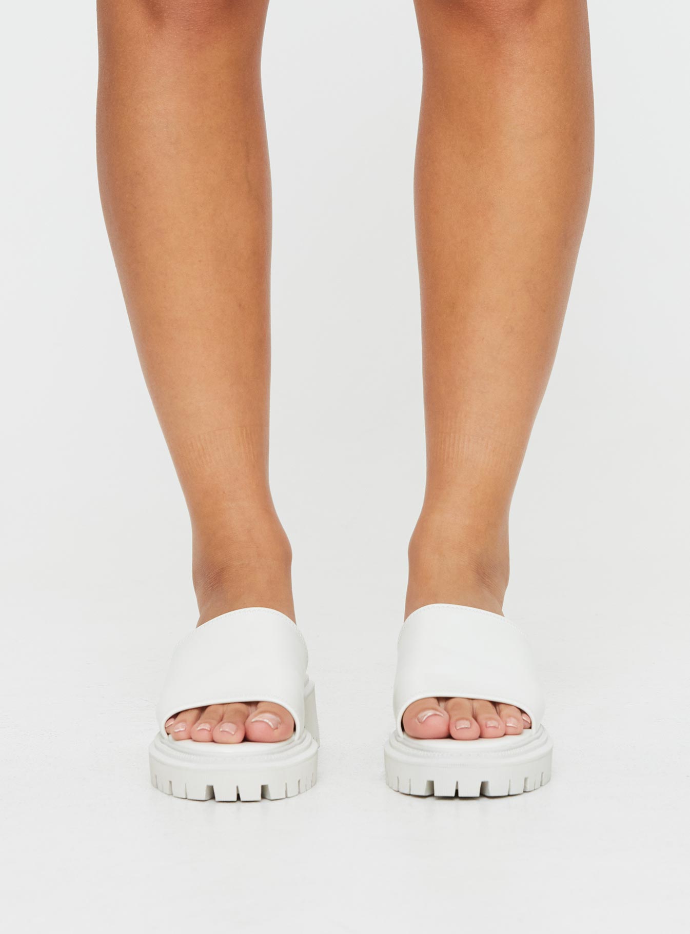 Faux leather slides Single thick strap upper, rounded toe, treaded sole, padded footbed