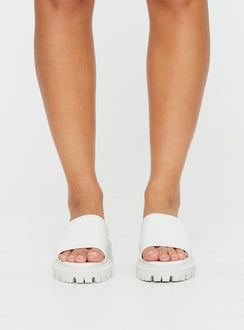 Faux leather slides Single thick strap upper, rounded toe, treaded sole, padded footbed