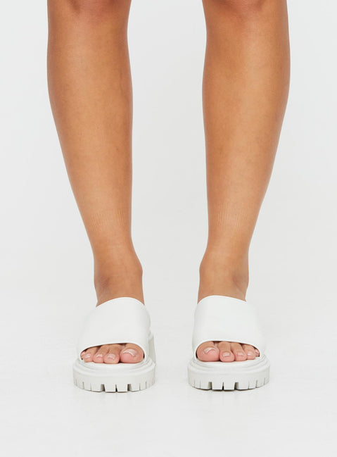 Faux leather slides Single thick strap upper, rounded toe, treaded sole, padded footbed