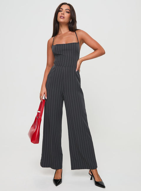 Jumpsuit fastening at back, invisible zip fastening, twin hip &amp; back pockets, partially exposed back, straight leg