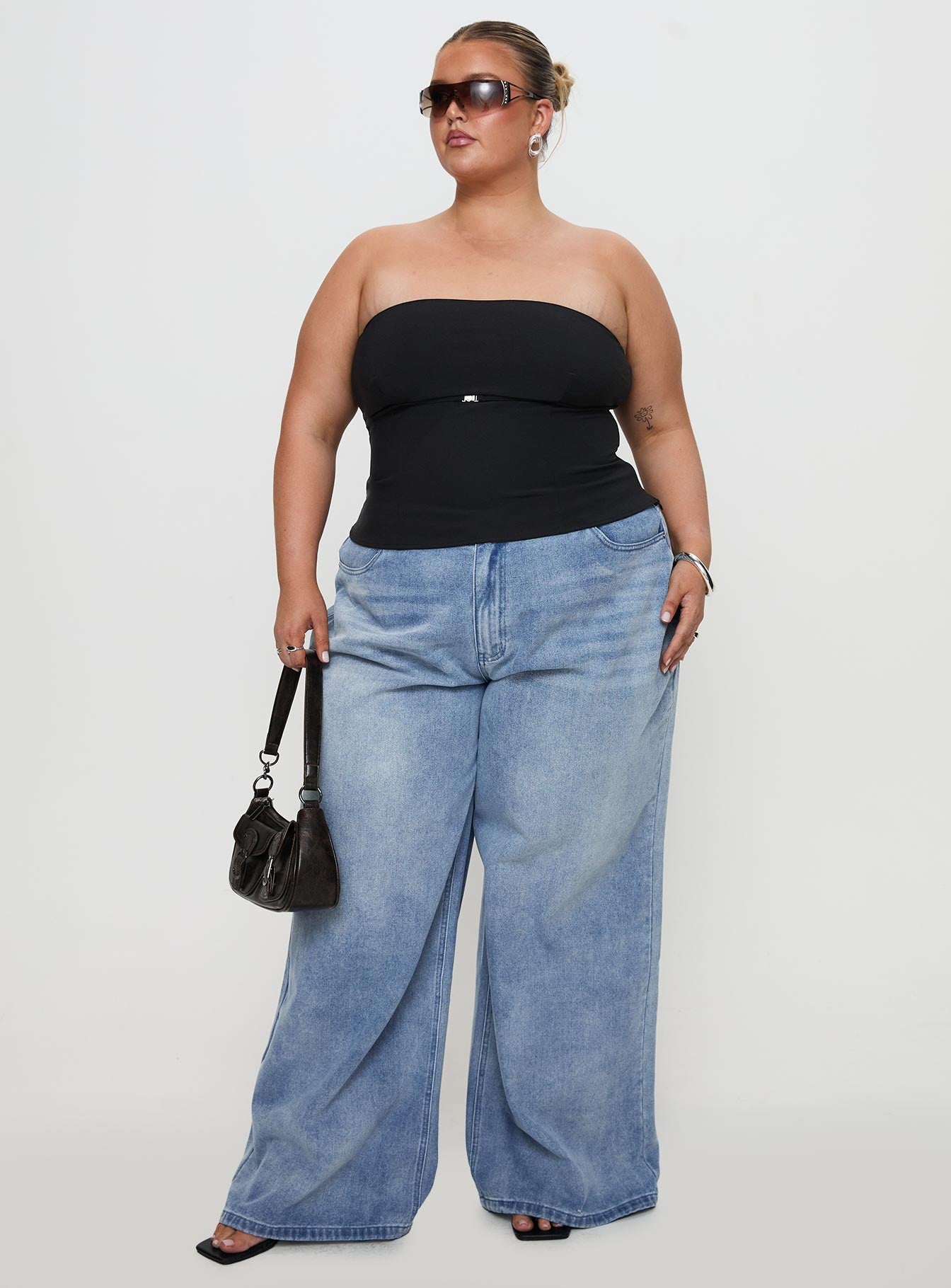 front view of model wearing Princess Polly Naylor Wide Leg Jeans Light Wash Denim Curve Mid Rise 