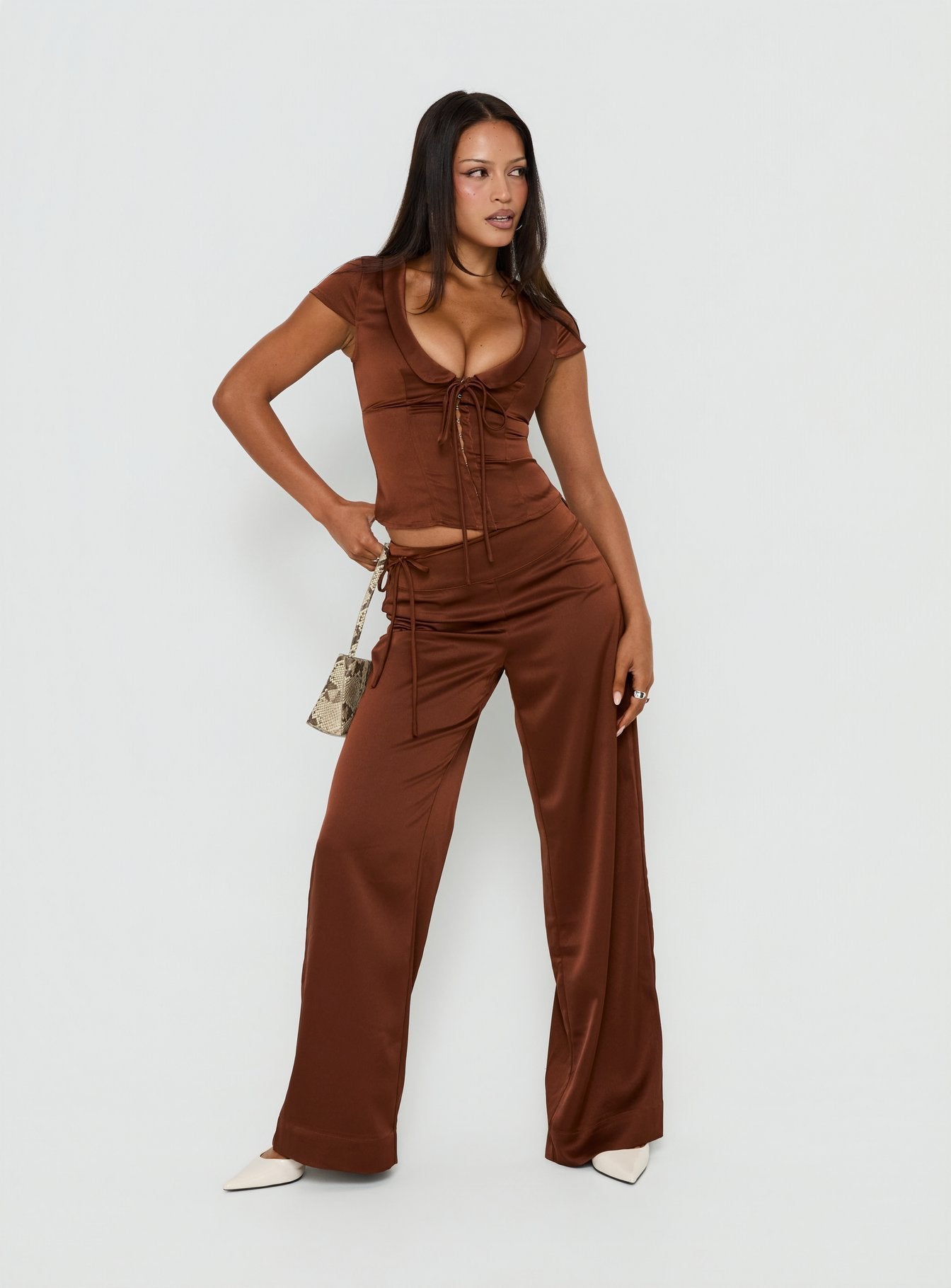 Featuring the Aubrette Satin Tie Pants Chocolate womens-regular-pants with high-rise wide-leg cut side view of model wearing Princess Polly