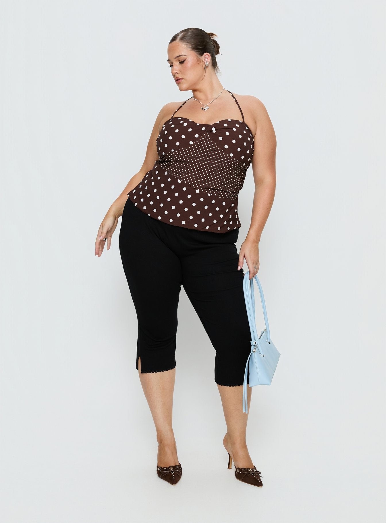 back view of model wearing Princess Polly Baseline Rib Capri Pants Black Curve Mid Rise Pants 