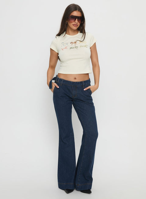side view of model wearing Princess Polly Acapulco Low Rise Flare Jeans Dark Blue Wash Low Rise Jeans 