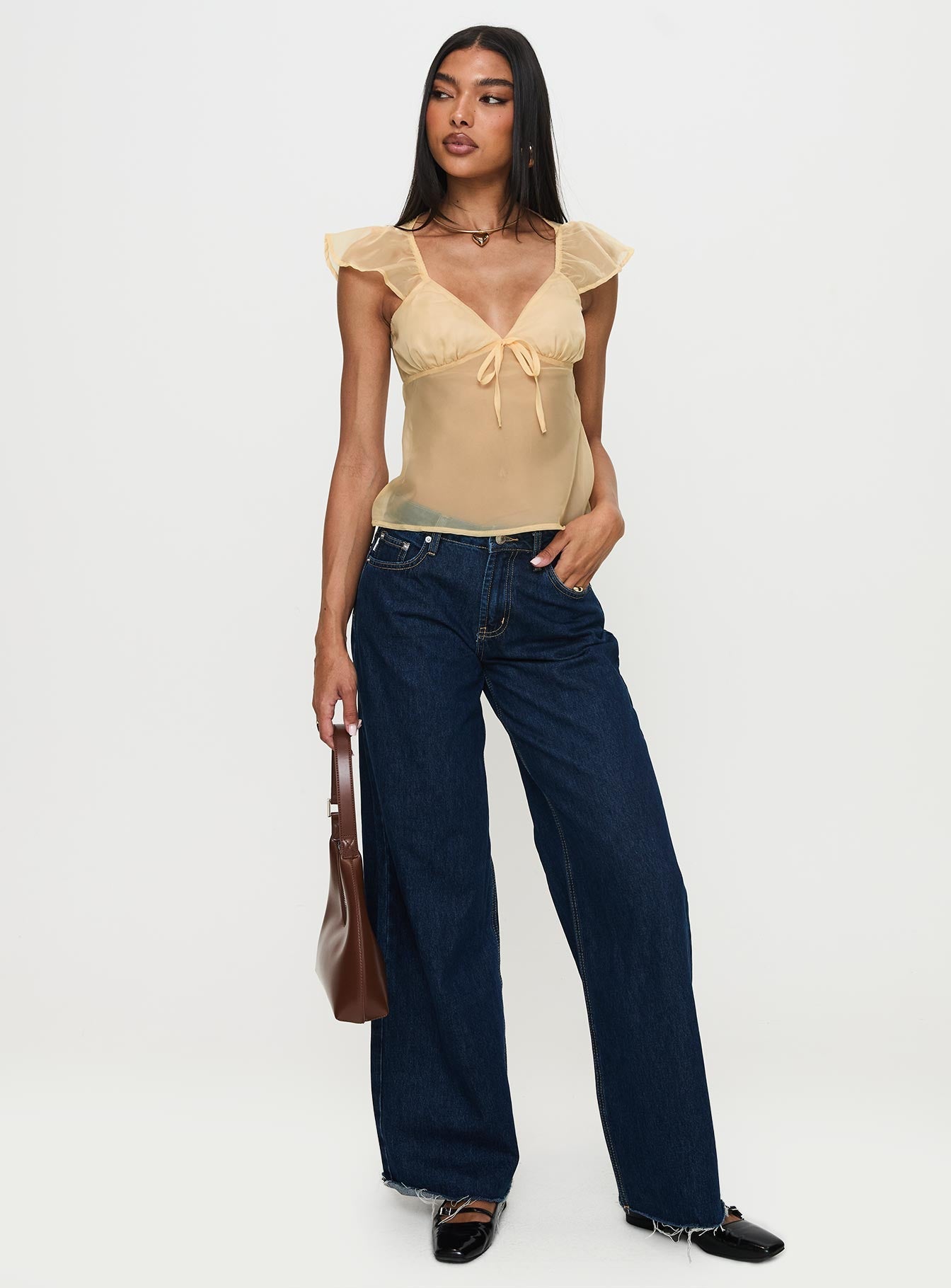 front view of model wearing Princess Polly Keysia Cap Sleeve Sheer Top Apricot Short Sleeves Plunger 