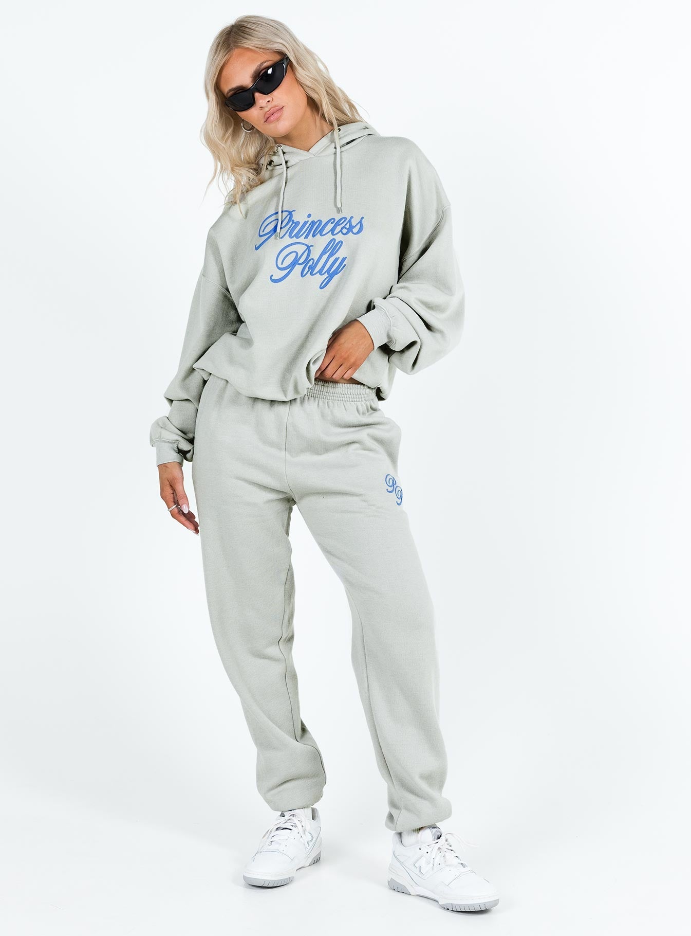 front view of model wearing Princess Polly Princess Polly Hooded Sweatshirt Cursive Text Grey / Blue regular 