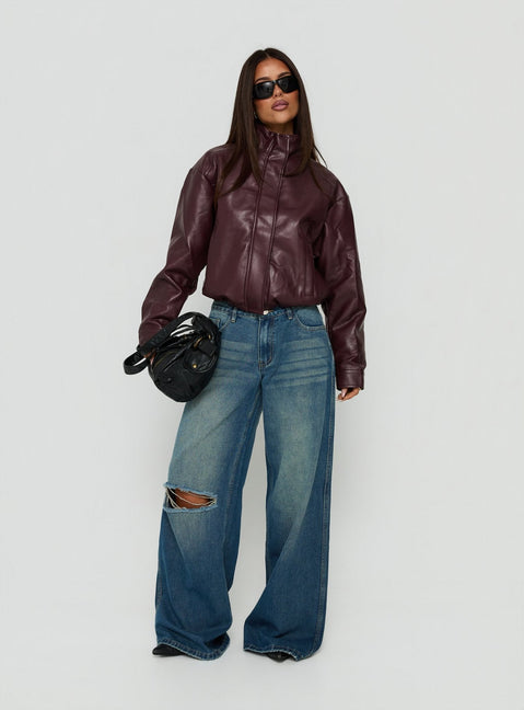 Showcasing the Ramos Low Rise Wide Leg Distressed Jeans Dark Indigo womens-jeans front view of model wearing Princess Polly