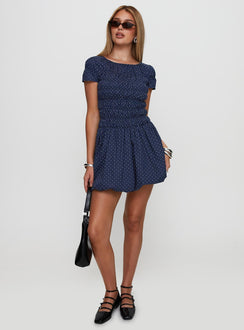 back view of model wearing Princess Polly Kennedia Shirred Bubble Hem Mini Dress Navy Boat Neck 