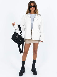 White jacket Classic collar Zip fastening at front Twin hip pockets  Chest pocket Press button fastening at cuff