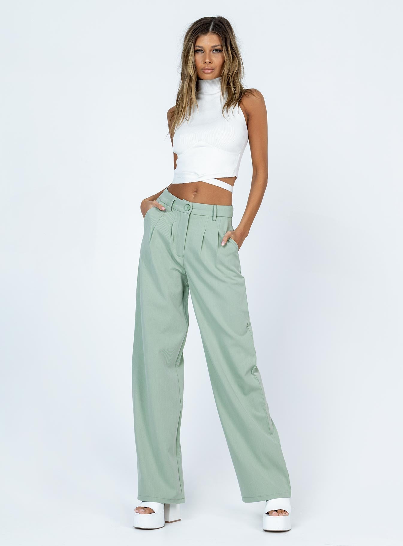 side view of model wearing Princess Polly Archer Pants Green 