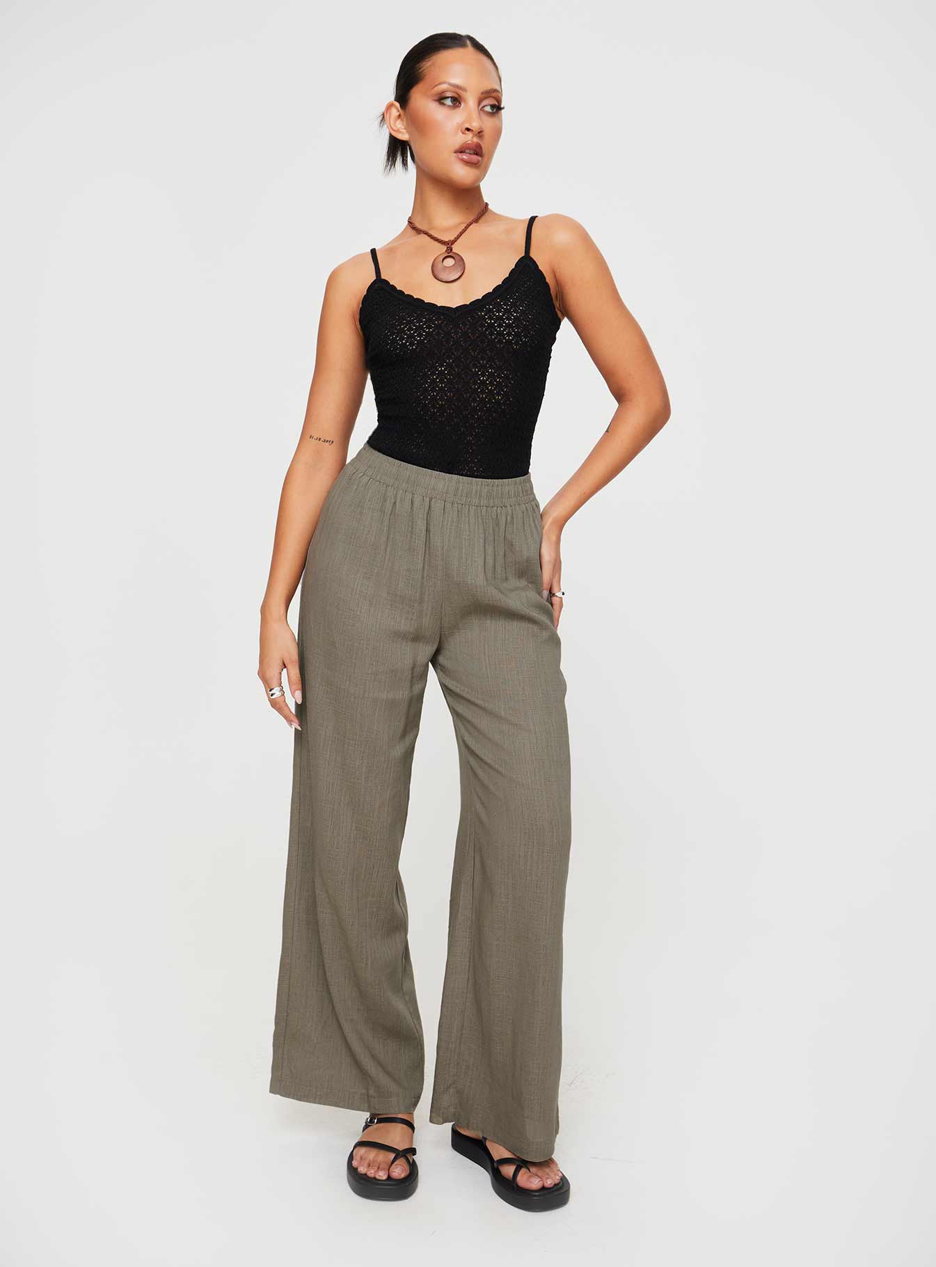 front view of model wearing Princess Polly Going For It Knit Bodysuit Black Sleeveless Asymmetric Neckline 