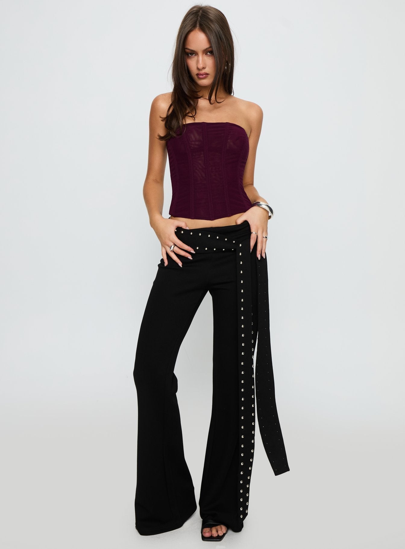 front view of model wearing Princess Polly Nikolia Studded Wrap Belt Pants Black Mid Rise Pants 