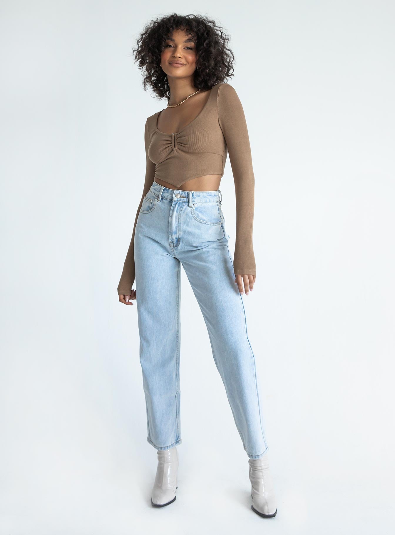 Long sleeve top Soft ribbed material Scooped neckline Gathered detail at bust Pointed front hem