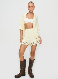 side view of model wearing Princess Polly Jamari Linen Blend Shorts Cream / Brown High Waisted Shorts 