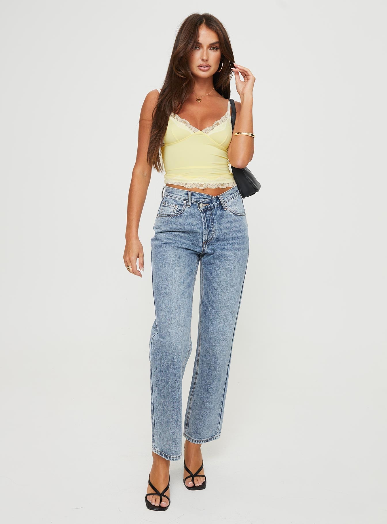 Mid rise denim jeans Asymmetrical waistband, relaxed straight leg, button front fastening, belt loops at waist, distressed detailing on hem