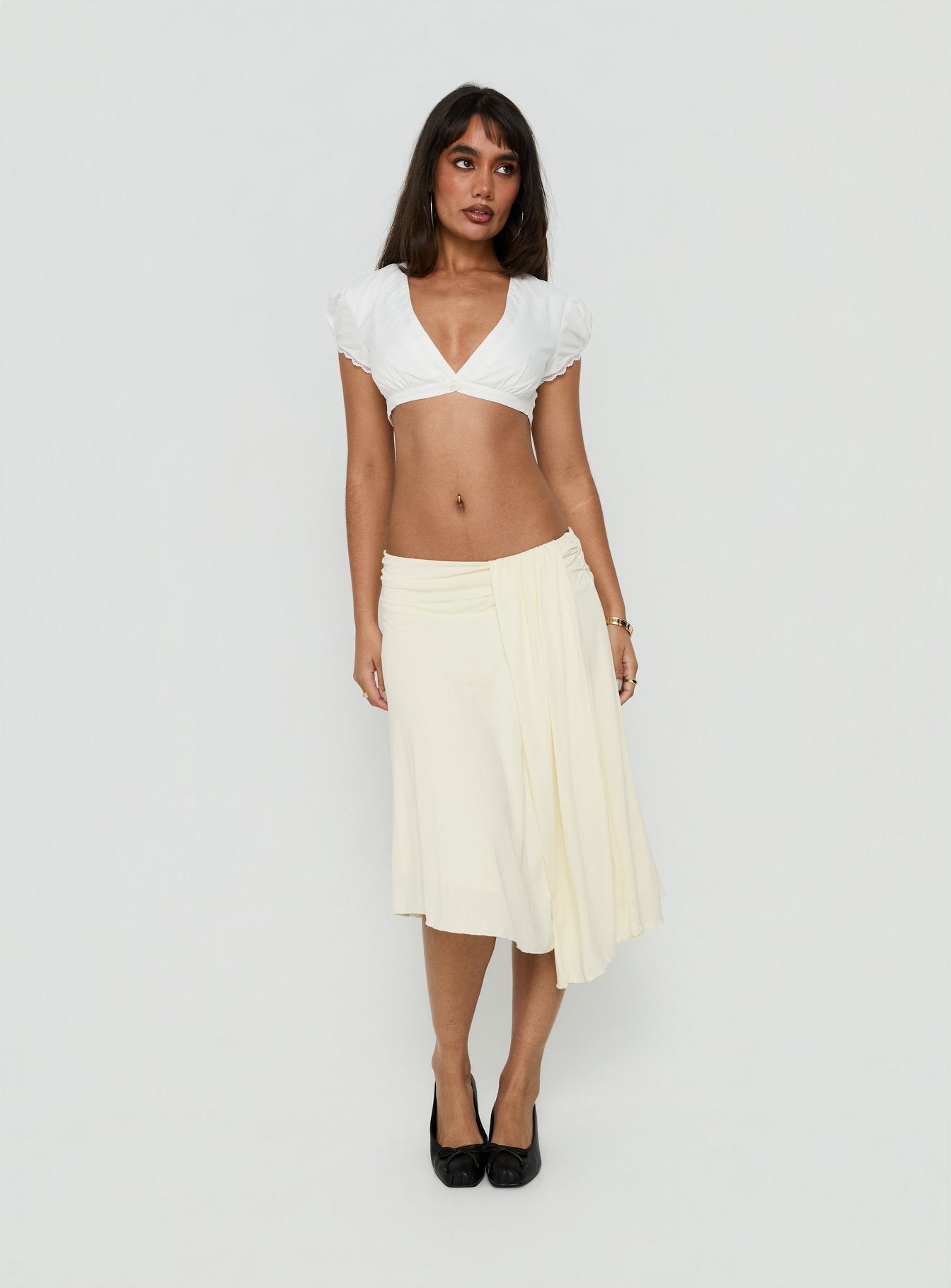 Crafted from cornsilk fabric, the Iselda Draped Midi Skirt Cream in womens-skirts features asymmetry Princess Polly