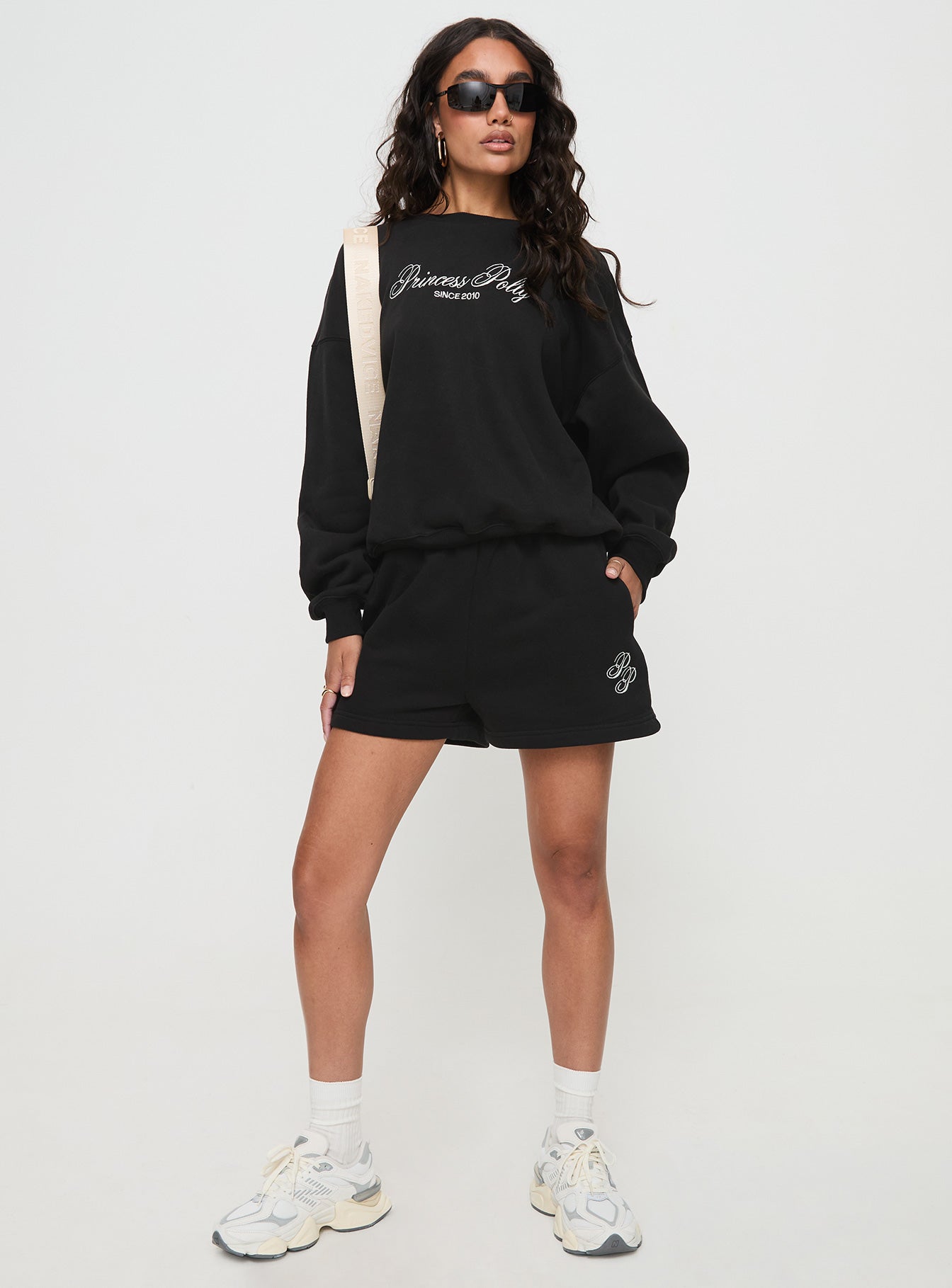 front view of model wearing Princess Polly Princess Polly Track Shorts Cursive Text Black Sand High Waisted Shorts 