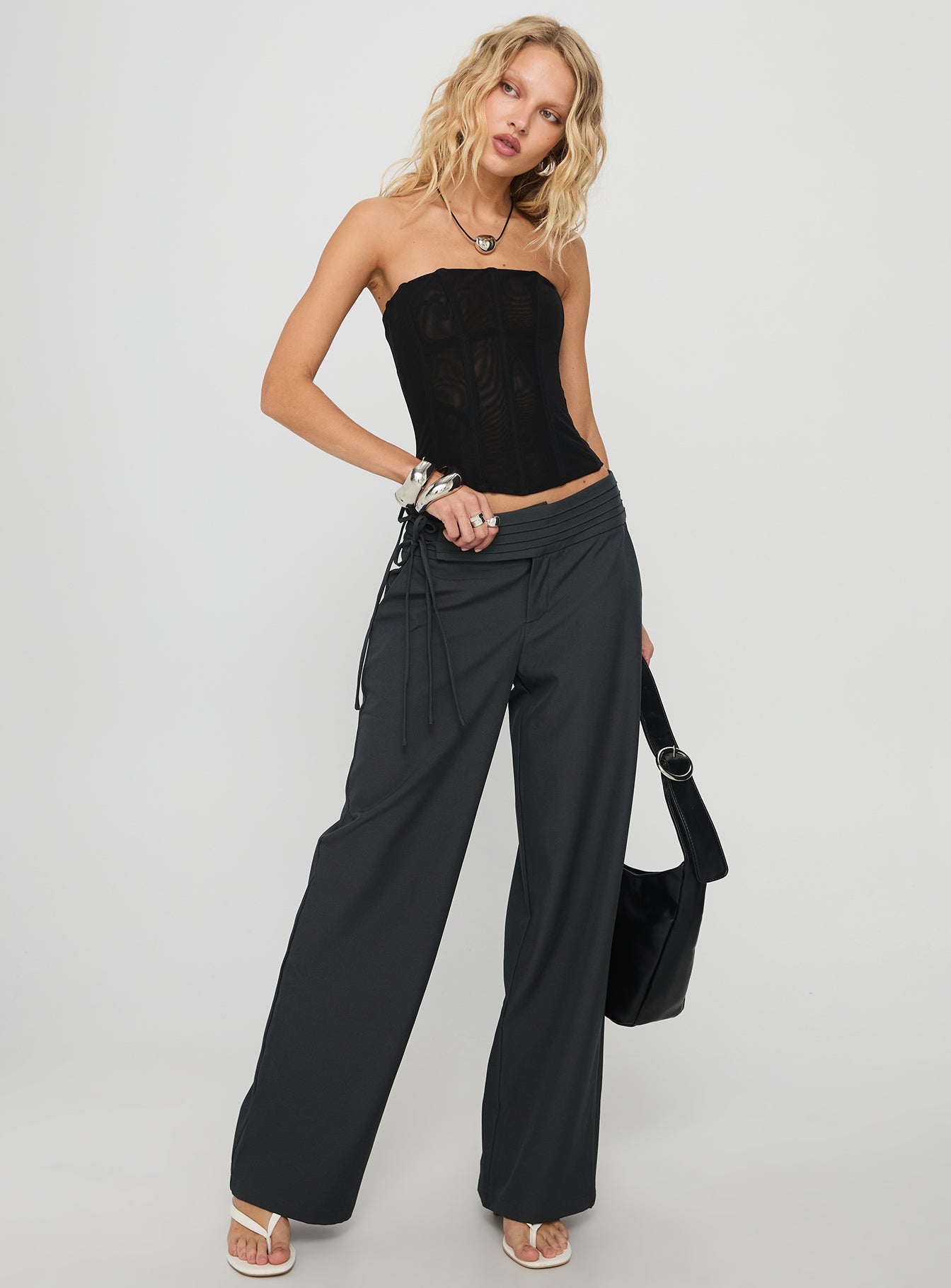 side view of model wearing Princess Polly Good Riddance Pleat Tie Slouch Pants Charcoal Low Rise Pants 