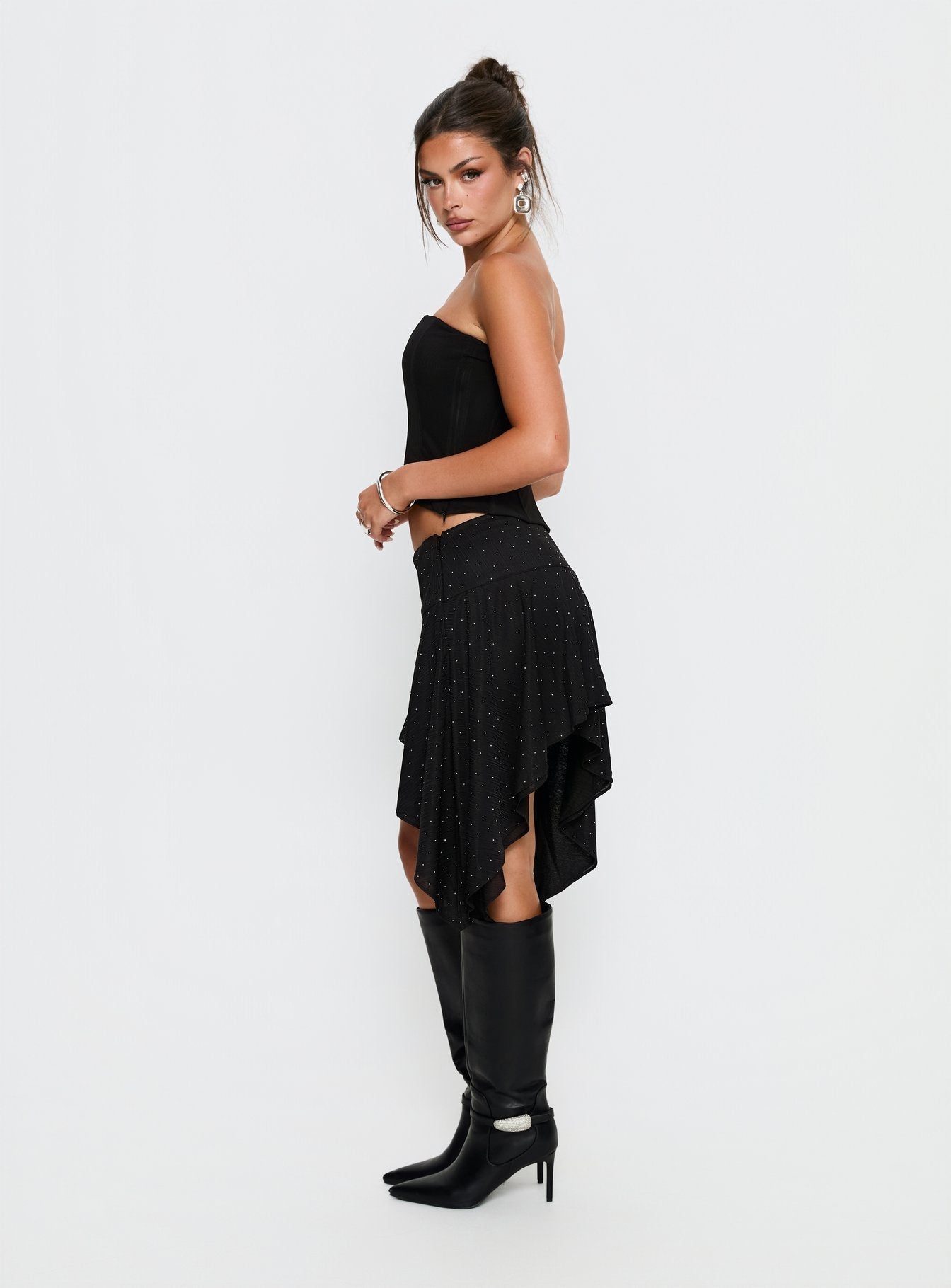   side view of model wearing Princess Polly Hevenna Asymmetrical Plisse Mini Skirt Black Diamante Mini Skirts 