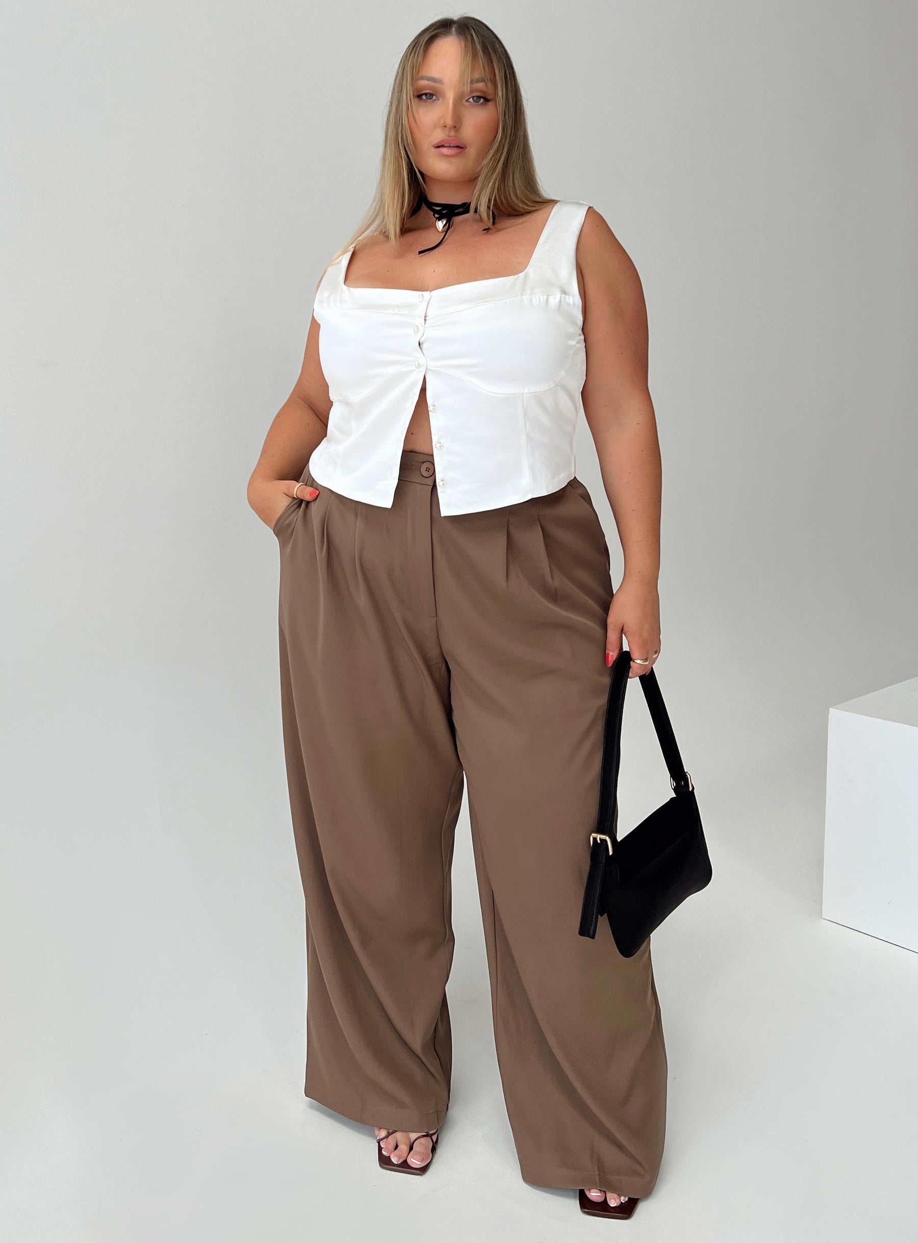 Front view of model wearing  front Princess Polly Sleeveless High Neck  Yeah The Pearls Top Ivory Curve