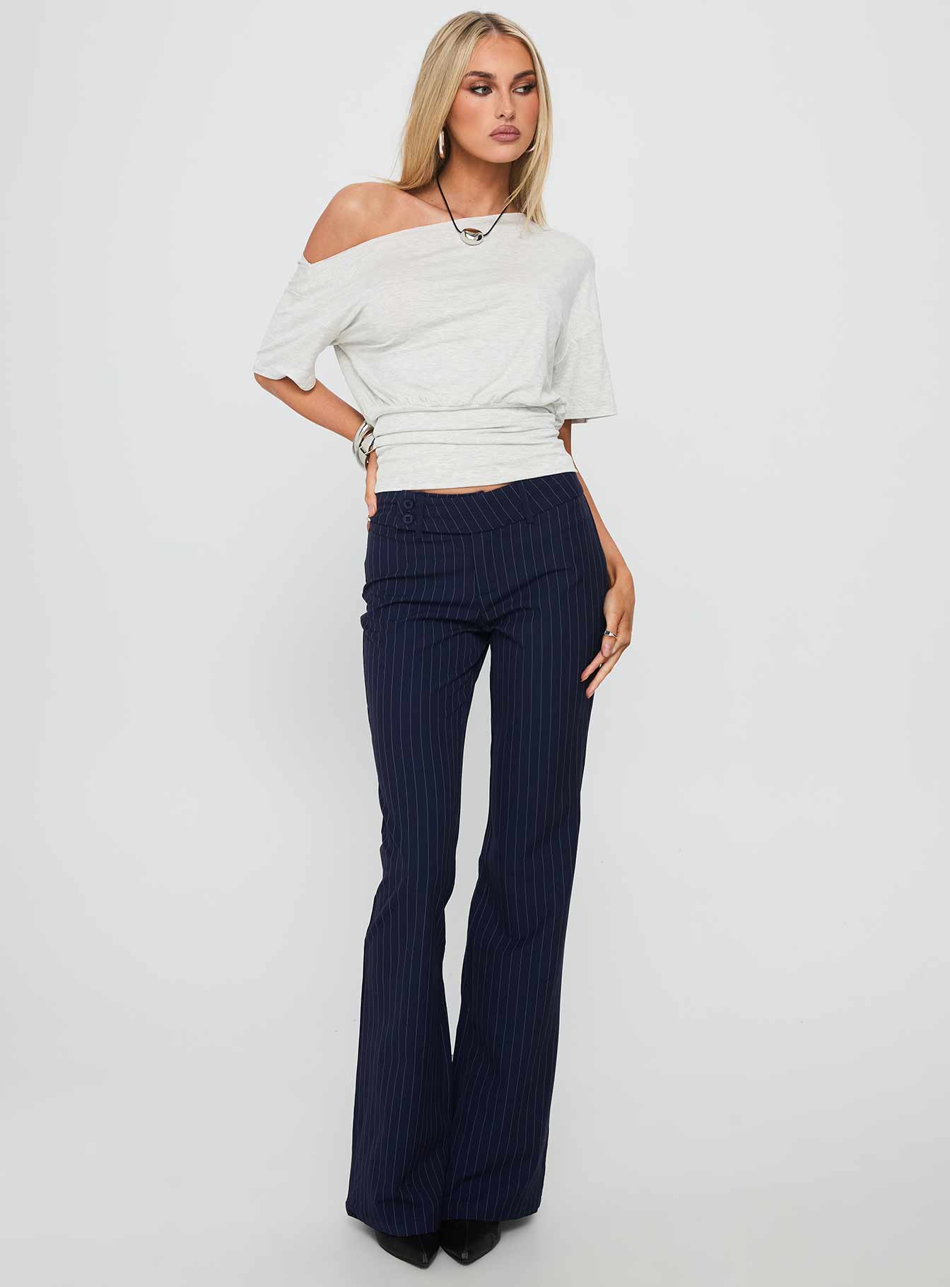 front view of model wearing Princess Polly Kinkirk Flared Pants Navy Pinstripe Low Rise Pants 