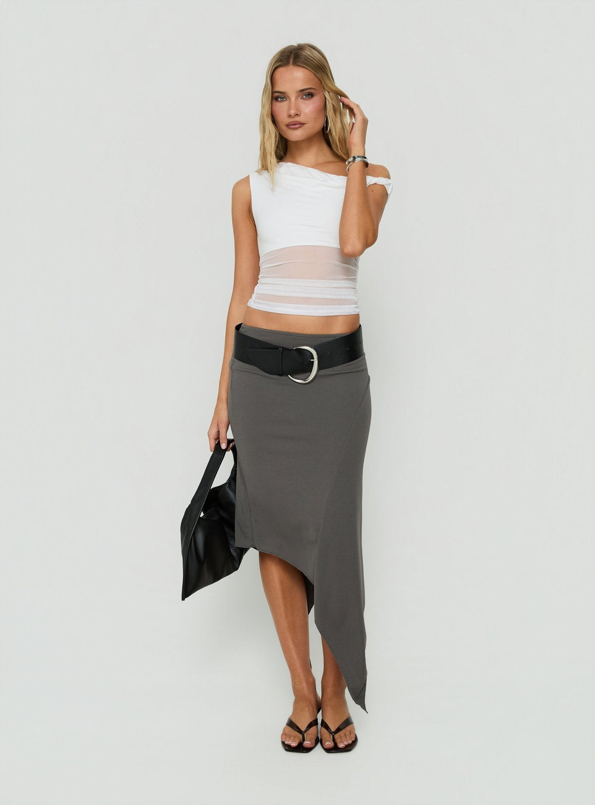 Highlighting the Aviza Asymmetrical Midi Skirt Grey in womens-skirts featuring fitted cut front view of model wearing Princess Polly