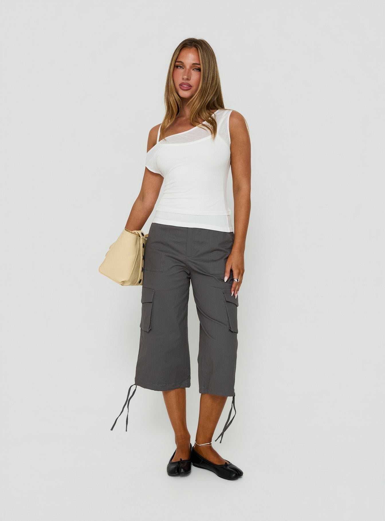 Featuring the Alfonza Utility Capri in Slate womens-regular-pants with mid-rise cargo styling front view of model wearing Princess Polly