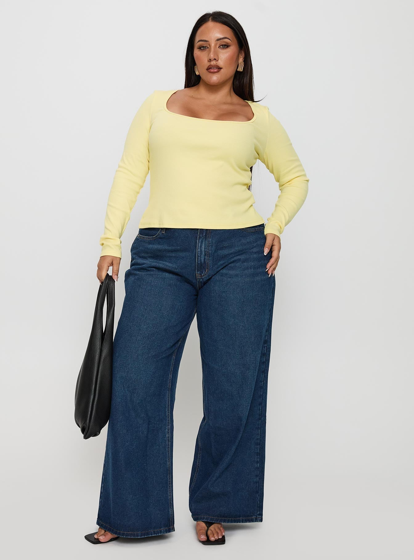 side view of model wearing Princess Polly Baseline Long Sleeve Top Yellow Curve Full Sleeves Scoop Neck 