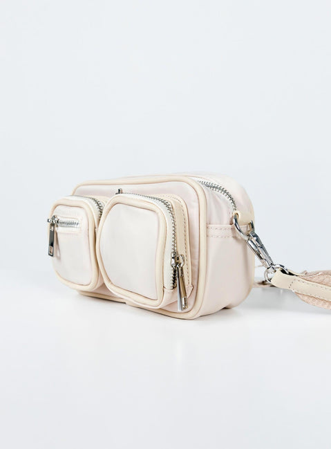 Crossbody bag Nylon material  Silver-toned hardware  Three external pockets  Zip fastenings  Internal pockets  Removable & adjustable strap  Flat base