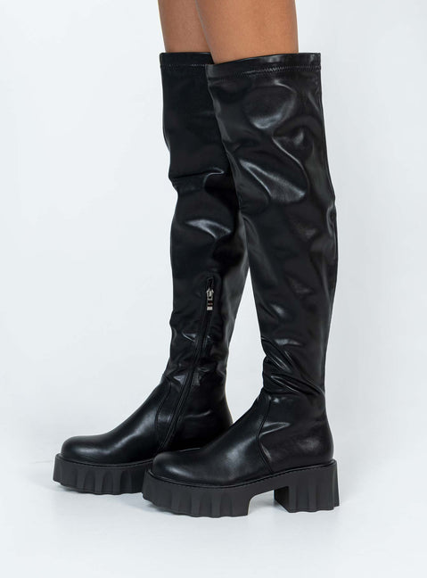 Thigh high boots Faux leather material Platform base Rounded toe Zip fastening at 