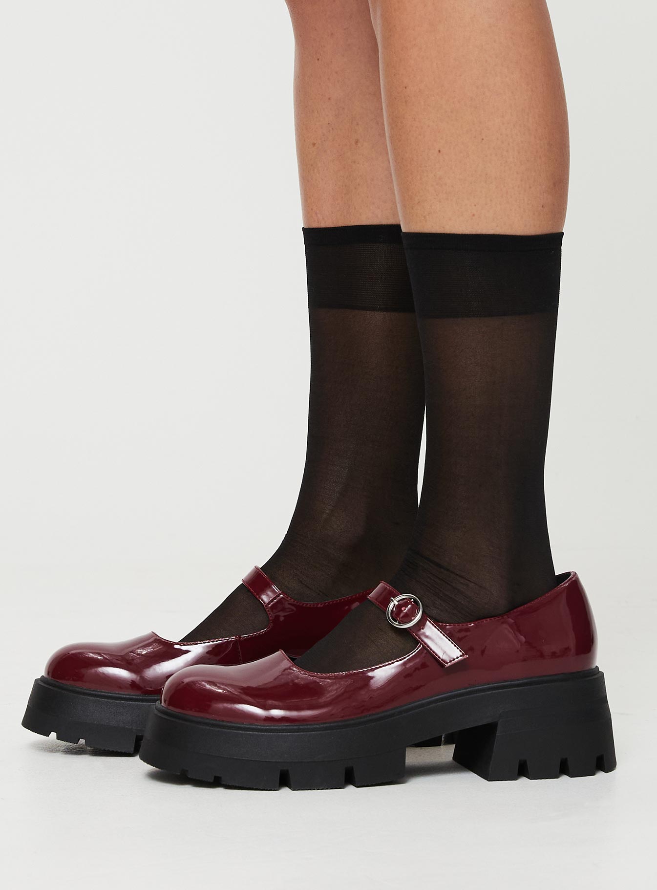 Faux patent leather loafer Platform base, treaded sole, single strap upper, silver-toned hardware, buckle fastening