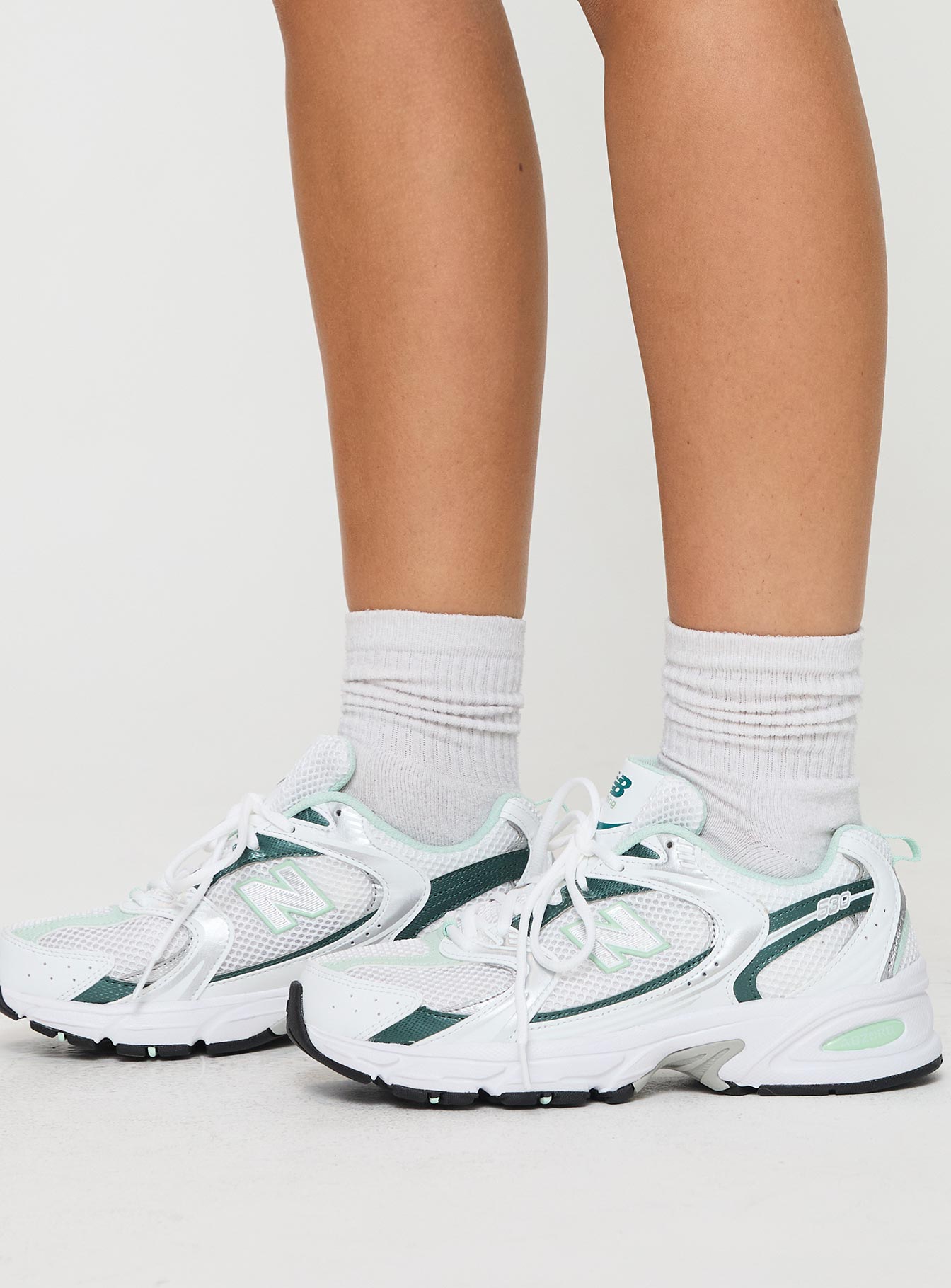 Mesh netting throughout, lace-up fastening, pull tab at heel