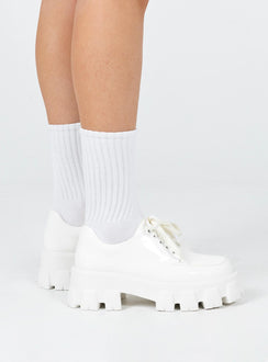 Platform shoes Faux leather material High shine finish Lace-up fastening Chunky treaded sole