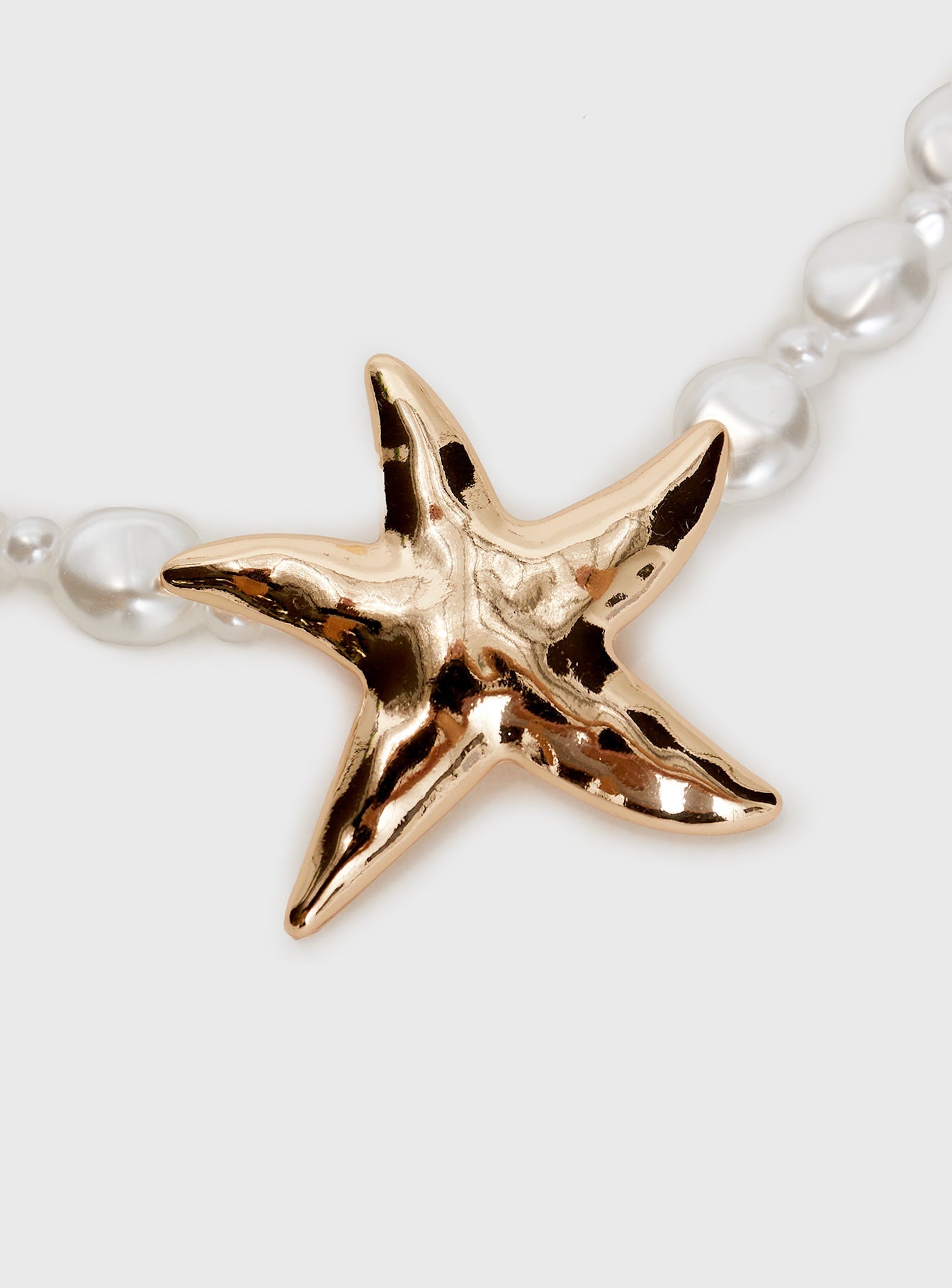 Necklace Beaded pear design, gold-toned star detail, lobster clasp fastening