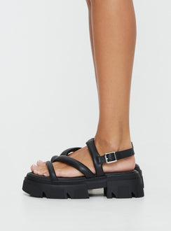 Faux leather sandals Rounded toe, chunky treaded sole, buckle fastening at ankle