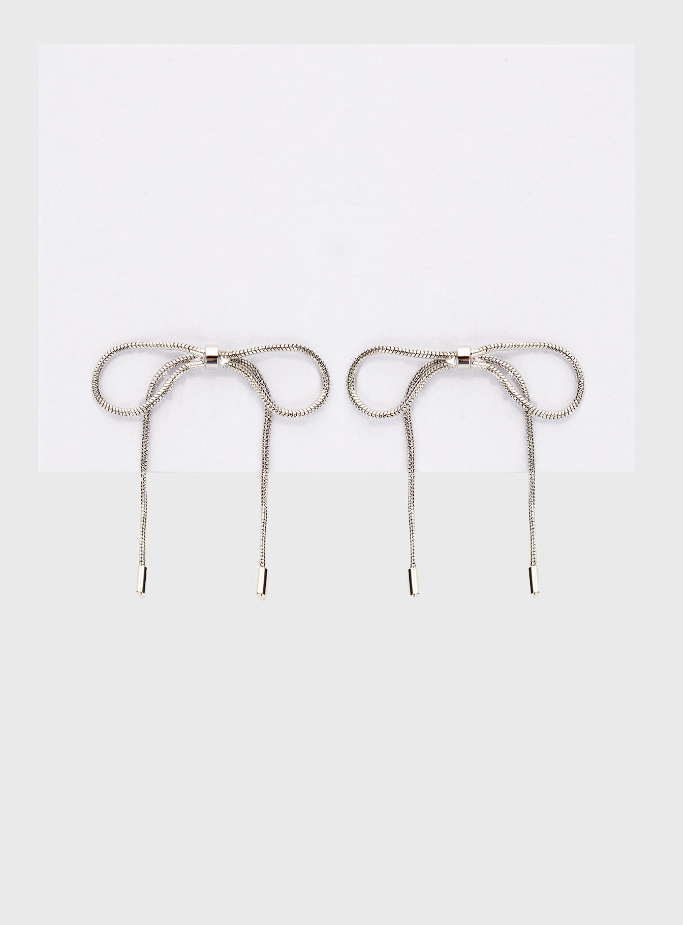 Silver-toned earrings Bow design, stud fastening
